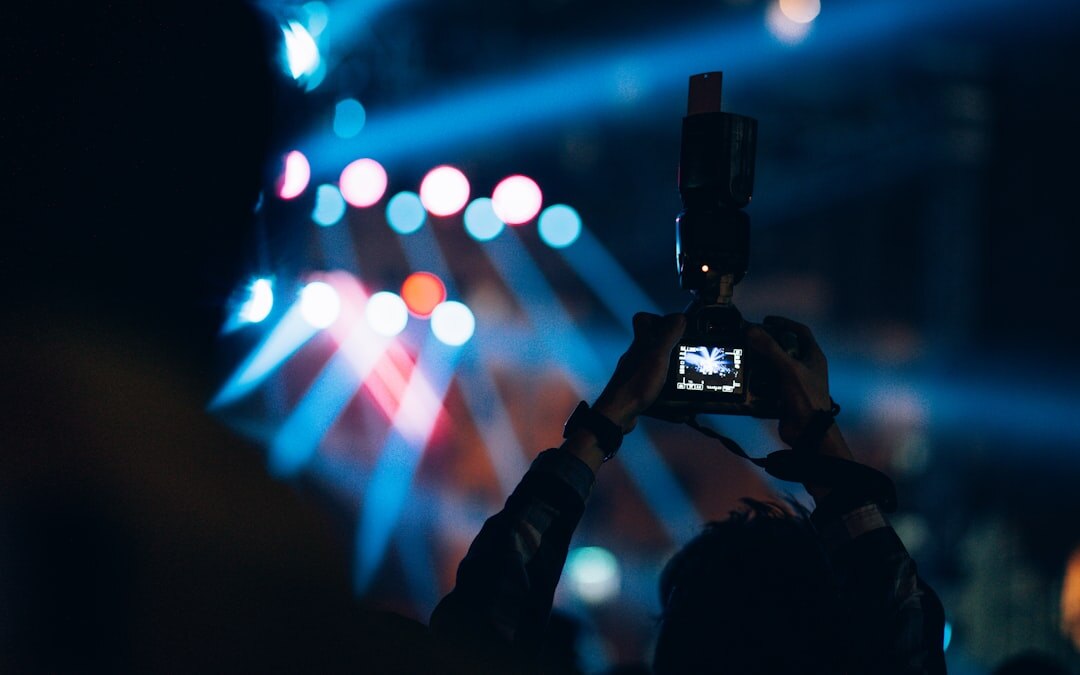 Camera operator filming a live event with a professional broadcast camera